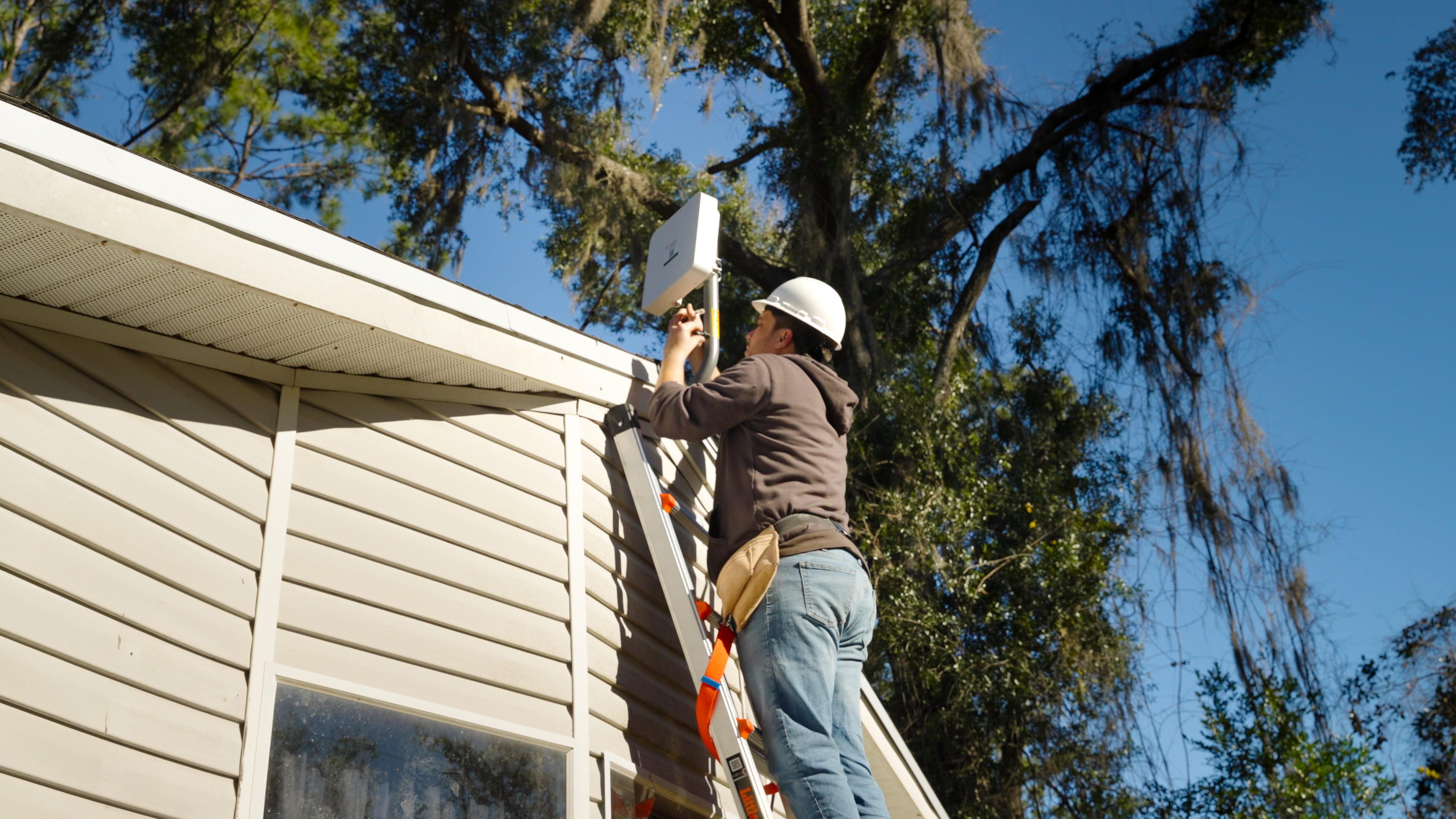 Trailrunner technician installing equipment on a home